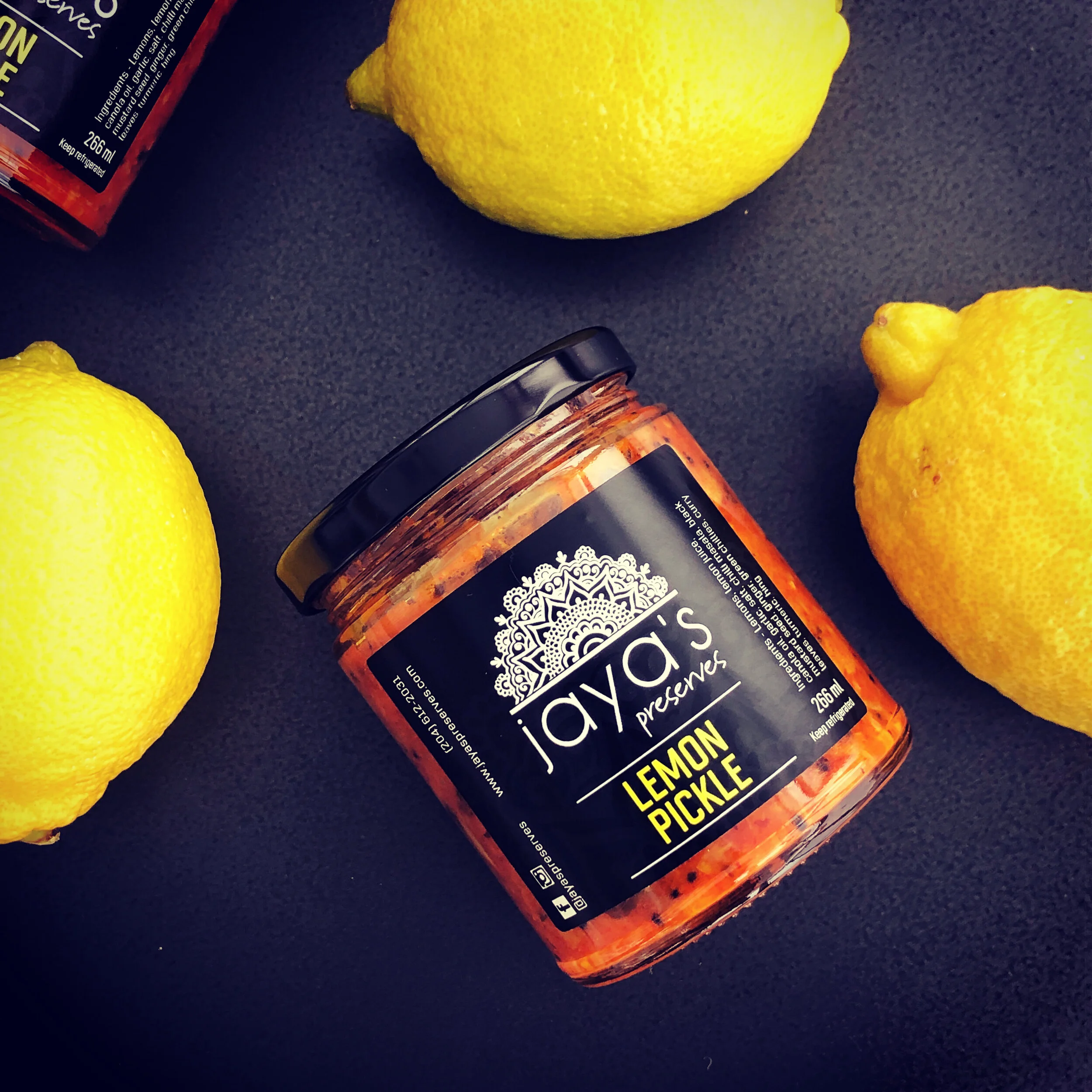 Lemon Pickle jar with fresh lemons
